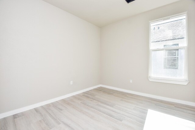 unfurnished room featuring light wood-style flooring and baseboards