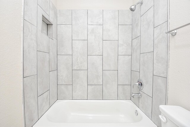 bathroom featuring toilet and shower / bathtub combination