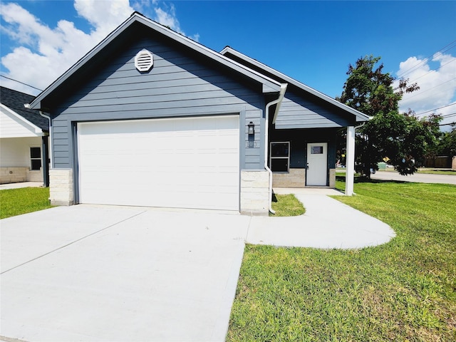 single story home with a front lawn, concrete driveway, and stone siding