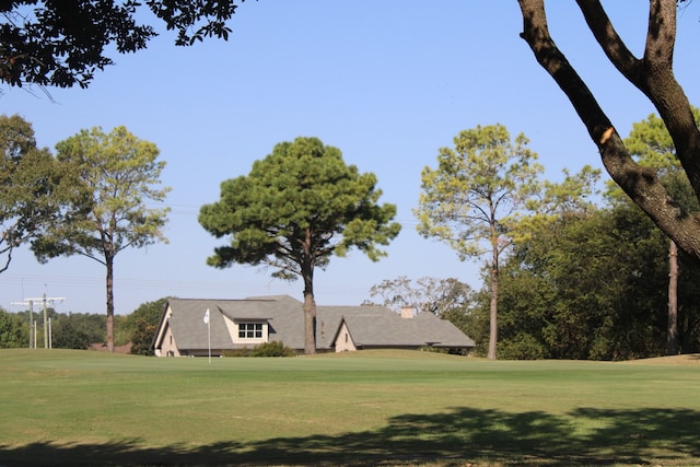 view of property's community with a lawn