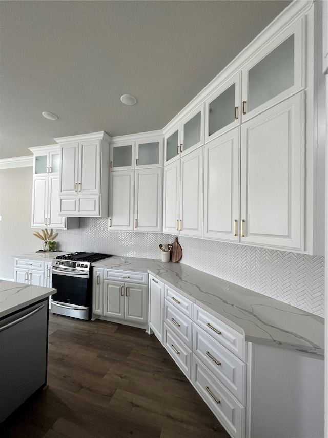 kitchen featuring stainless steel gas stove, white cabinetry, light stone counters, and dark hardwood / wood-style flooring