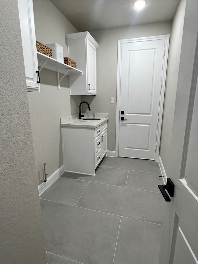 washroom featuring light tile patterned flooring and sink