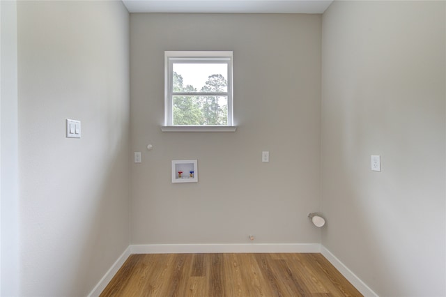 laundry area with washer hookup, hookup for a gas dryer, and light hardwood / wood-style flooring