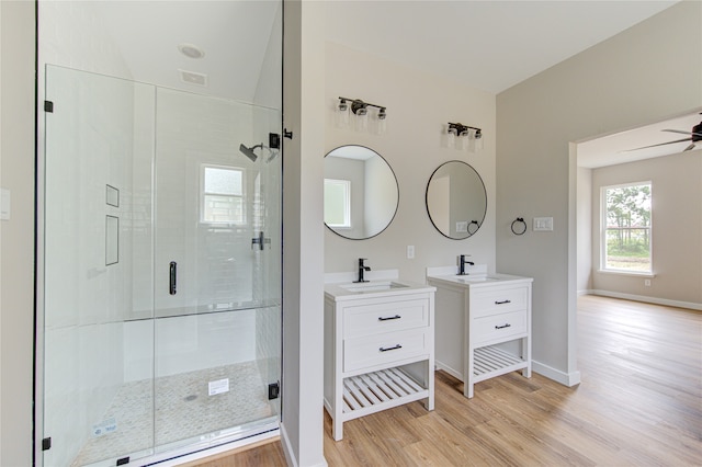 bathroom featuring walk in shower, wood-type flooring, vanity, and ceiling fan