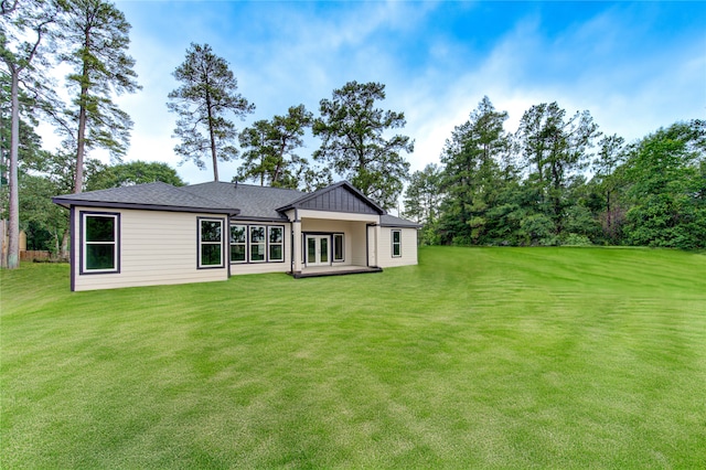 rear view of property with a yard