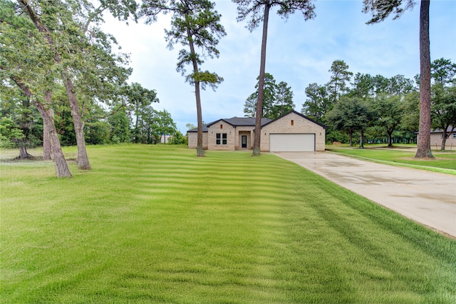 ranch-style house featuring a garage and a front lawn