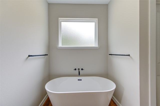 bathroom featuring a bathtub and hardwood / wood-style flooring