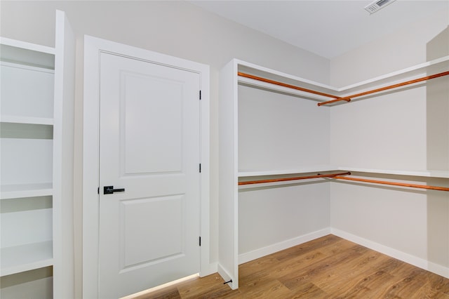 walk in closet featuring light hardwood / wood-style flooring