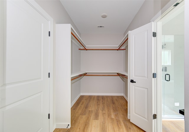 walk in closet featuring light hardwood / wood-style floors