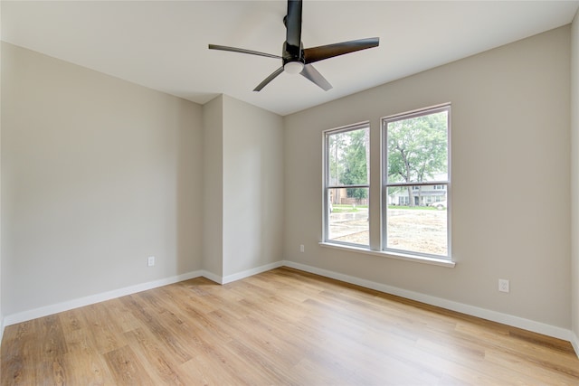 spare room with light wood-type flooring and ceiling fan