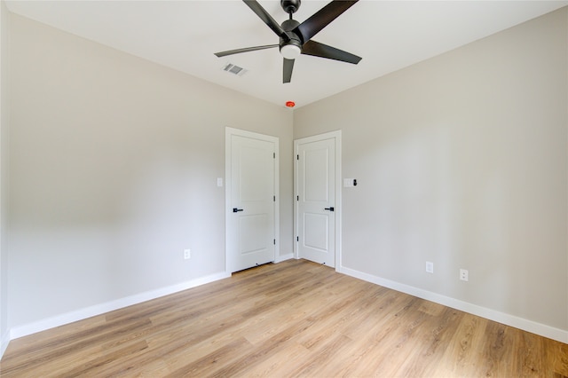 empty room featuring ceiling fan and light hardwood / wood-style floors