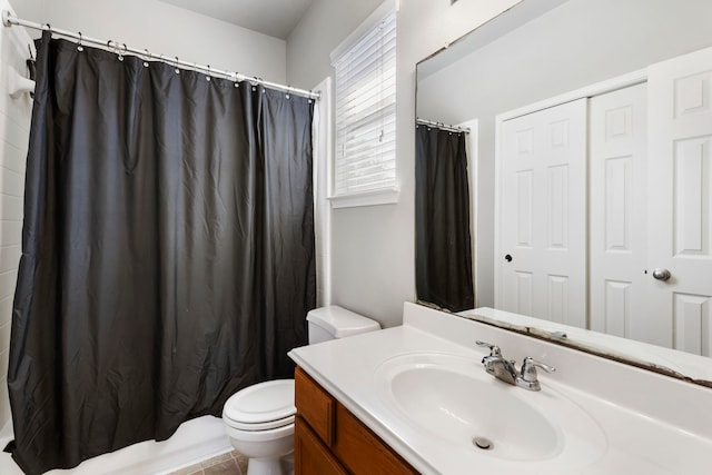 full bathroom featuring vanity, shower / bath combo with shower curtain, toilet, and tile patterned flooring