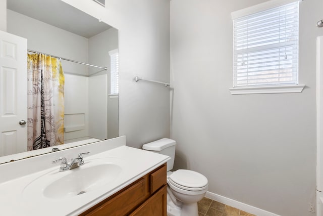 bathroom featuring toilet, vanity, and a shower with shower curtain