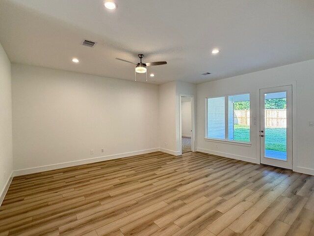 spare room featuring ceiling fan and light hardwood / wood-style flooring