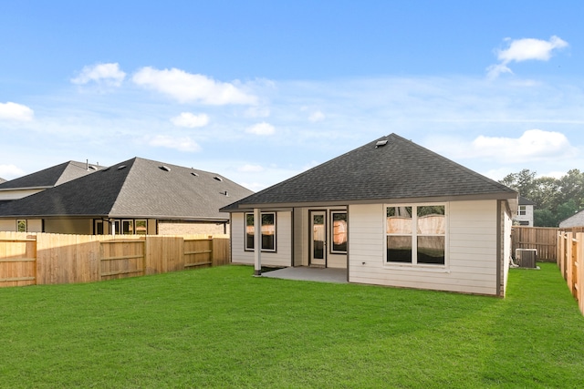 rear view of property featuring a yard, a patio, and central AC