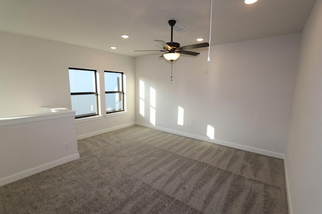 spare room featuring ceiling fan and carpet flooring