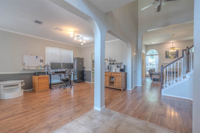 office with light hardwood / wood-style floors, ceiling fan, and ornamental molding