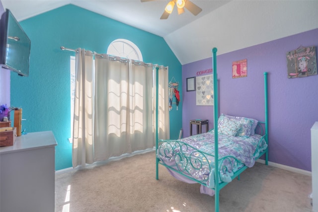 carpeted bedroom featuring ceiling fan and vaulted ceiling