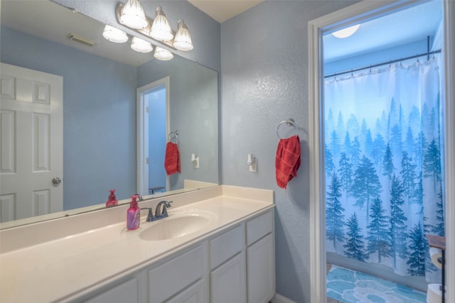 bathroom with a shower with curtain and vanity