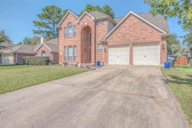 view of property with a garage and a front yard