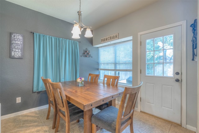 dining space with a chandelier and light tile patterned flooring