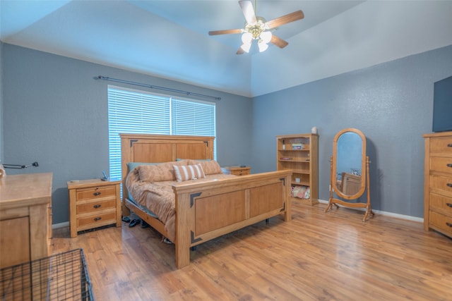 bedroom featuring ceiling fan, lofted ceiling, and light hardwood / wood-style flooring