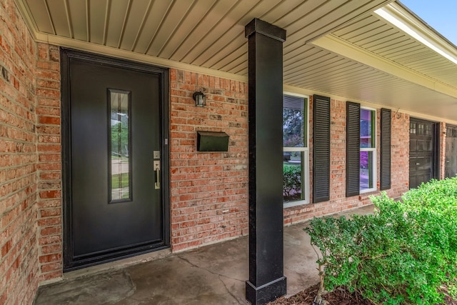 view of exterior entry with a porch