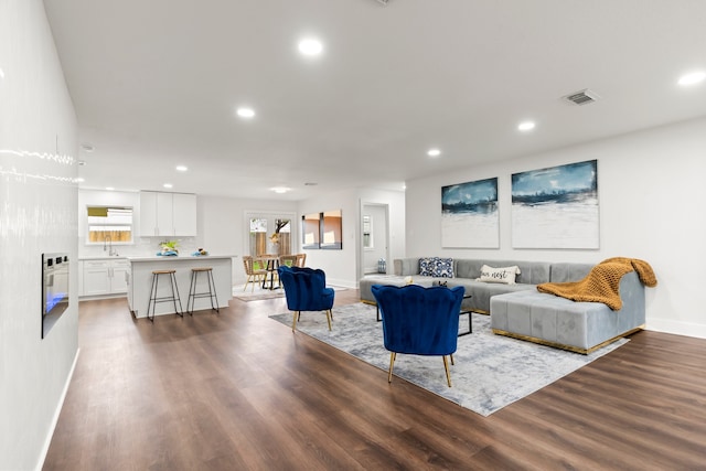 living room with sink and dark hardwood / wood-style flooring