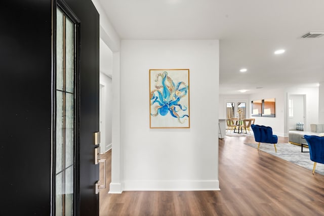 corridor with hardwood / wood-style floors