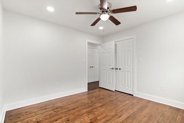 unfurnished bedroom with ceiling fan and hardwood / wood-style floors