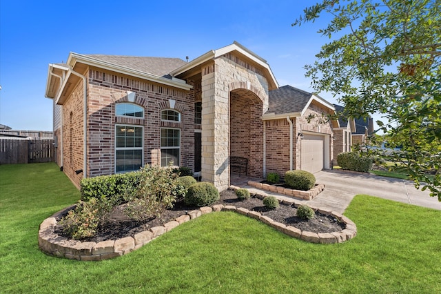 view of front of property with a front lawn and a garage