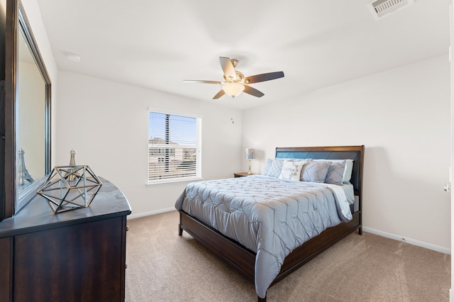 bedroom featuring light carpet, ceiling fan, and a closet