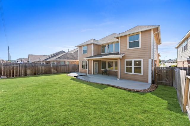 rear view of property featuring a lawn and a patio