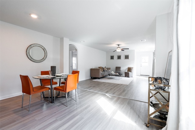 dining space with ceiling fan and light hardwood / wood-style floors