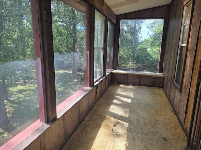 unfurnished sunroom featuring plenty of natural light and vaulted ceiling