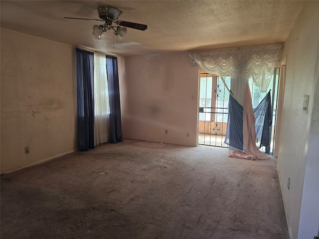 spare room featuring carpet flooring, a textured ceiling, and ceiling fan