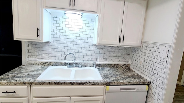 kitchen featuring backsplash, white cabinetry, sink, and white dishwasher