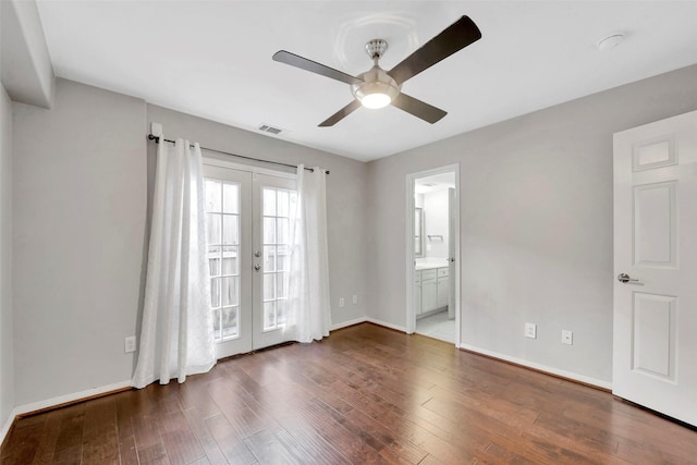 spare room featuring ceiling fan, dark wood-type flooring, and french doors