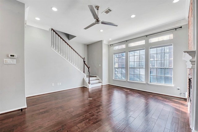 unfurnished living room featuring ceiling fan, plenty of natural light, dark hardwood / wood-style floors, and ornamental molding