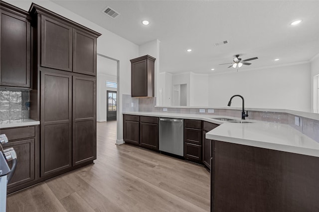 kitchen featuring dishwasher, ceiling fan, sink, light hardwood / wood-style flooring, and backsplash