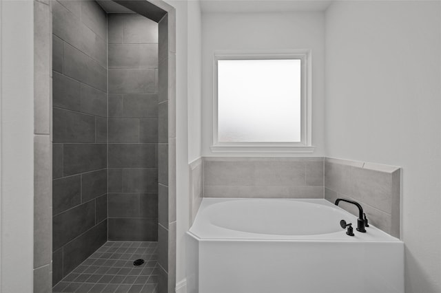 bathroom featuring separate shower and tub