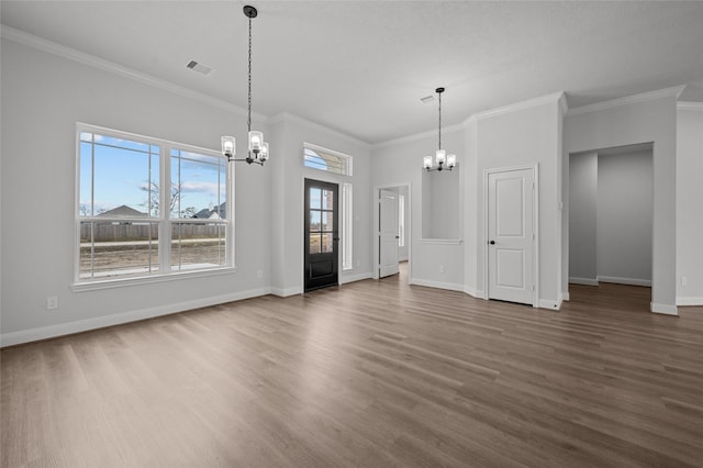 unfurnished living room featuring a notable chandelier, dark hardwood / wood-style flooring, and crown molding