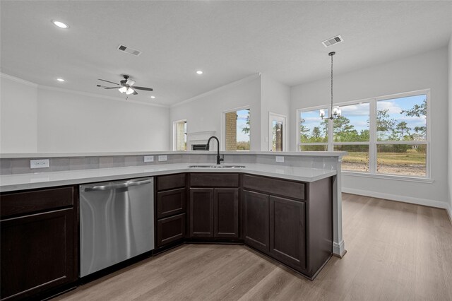 kitchen with dishwasher, light wood-type flooring, pendant lighting, sink, and ceiling fan with notable chandelier