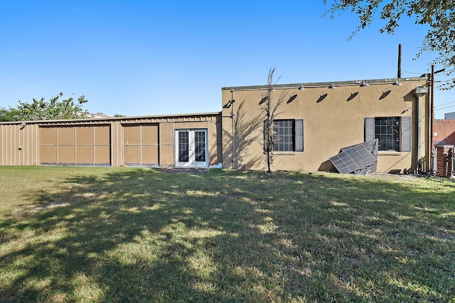 rear view of house featuring a lawn