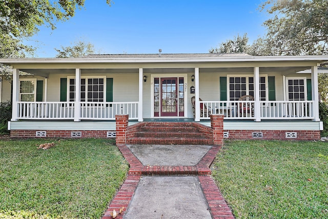 ranch-style house featuring a front lawn and covered porch