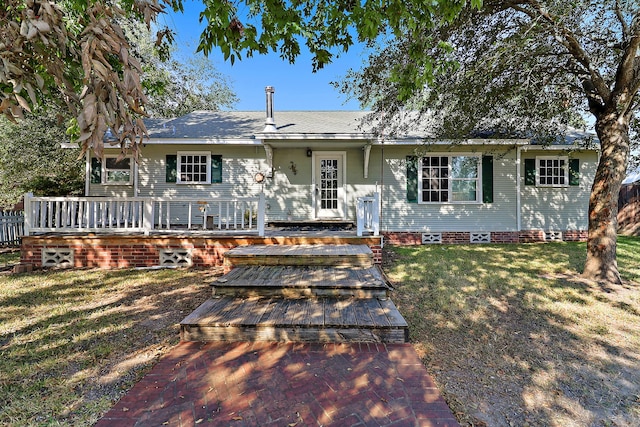 view of front of home featuring a front yard and a deck