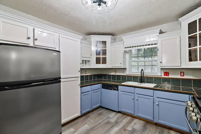 kitchen with white cabinetry, appliances with stainless steel finishes, and sink