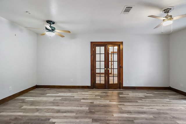 spare room featuring light hardwood / wood-style floors, french doors, and ceiling fan