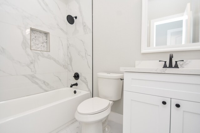 full bathroom featuring vanity, tiled shower / bath combo, and toilet