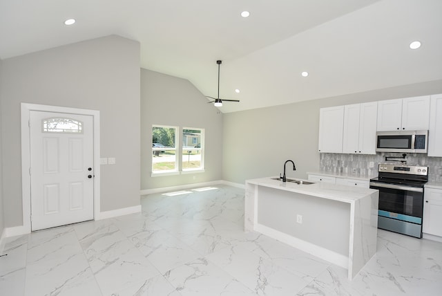 kitchen featuring a center island with sink, white cabinetry, sink, and stainless steel appliances